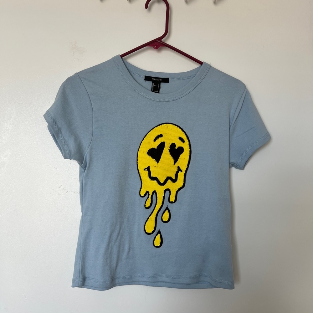 Baby blue top with sequin smiley face